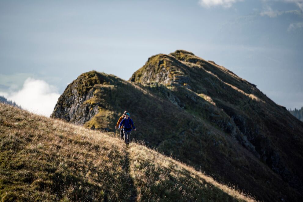 Two people hiking along a mountain ridge
