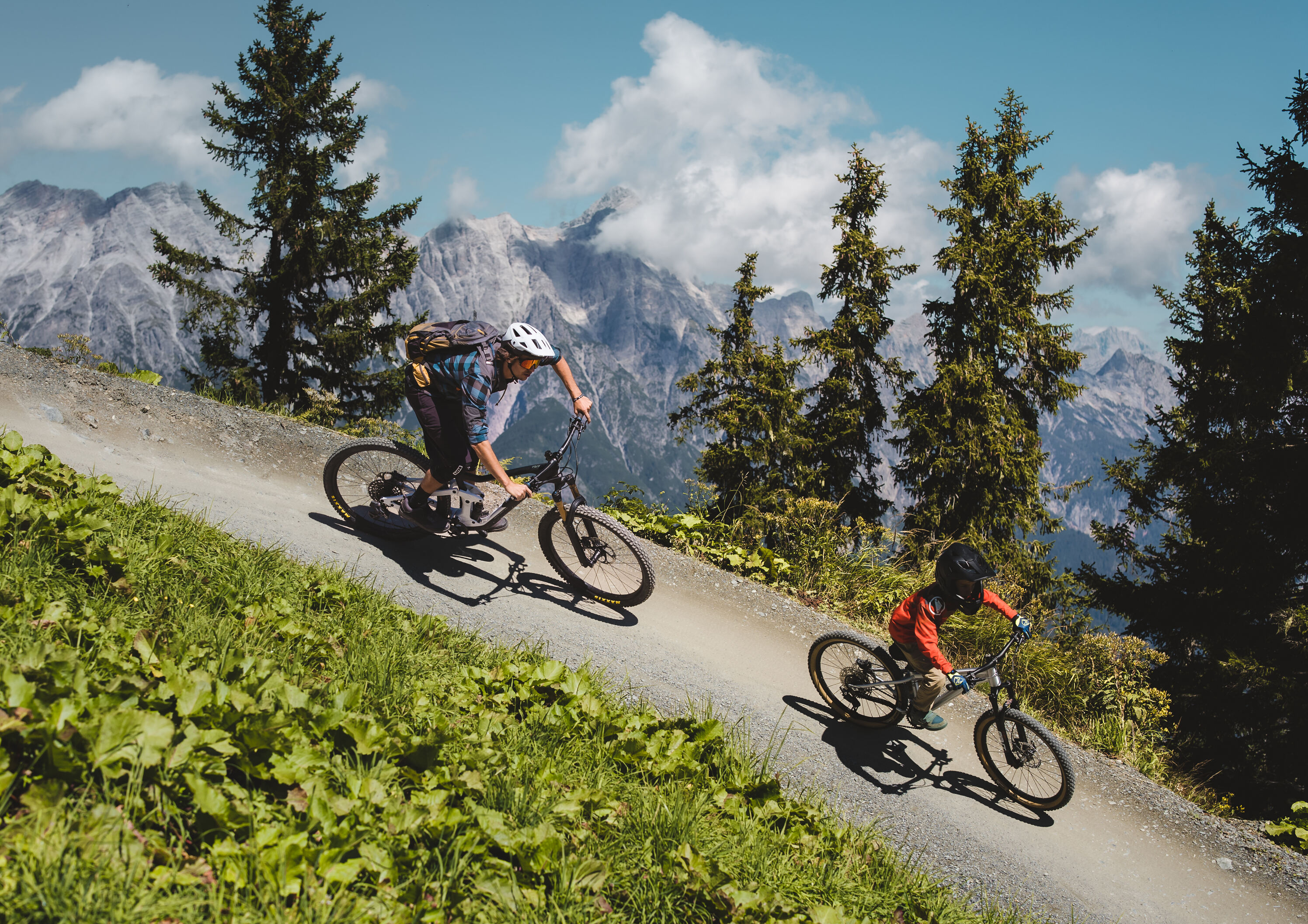 Father and son on a bike trail in the Alps