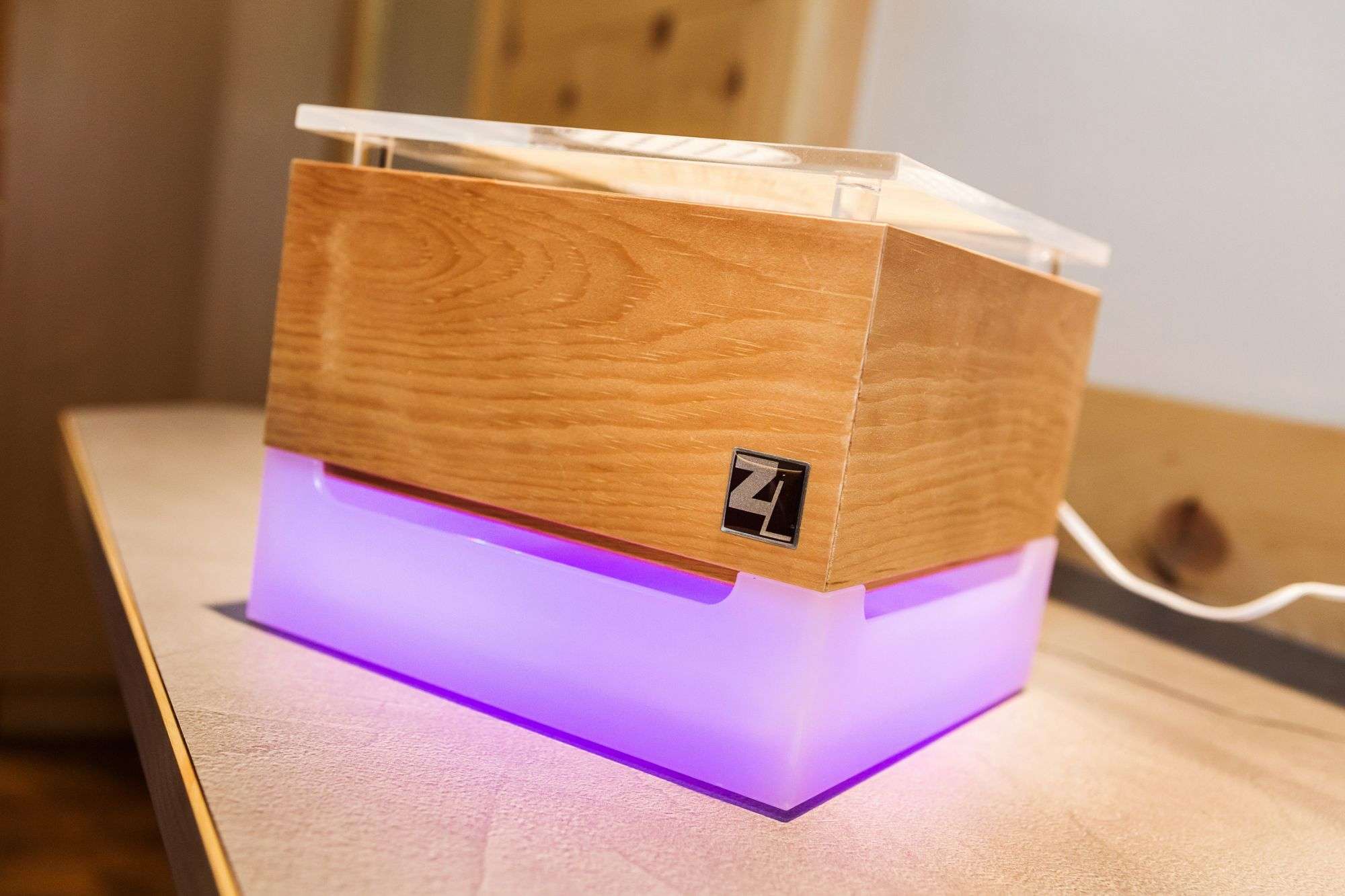 A cube made of wood, the lower part glows violet